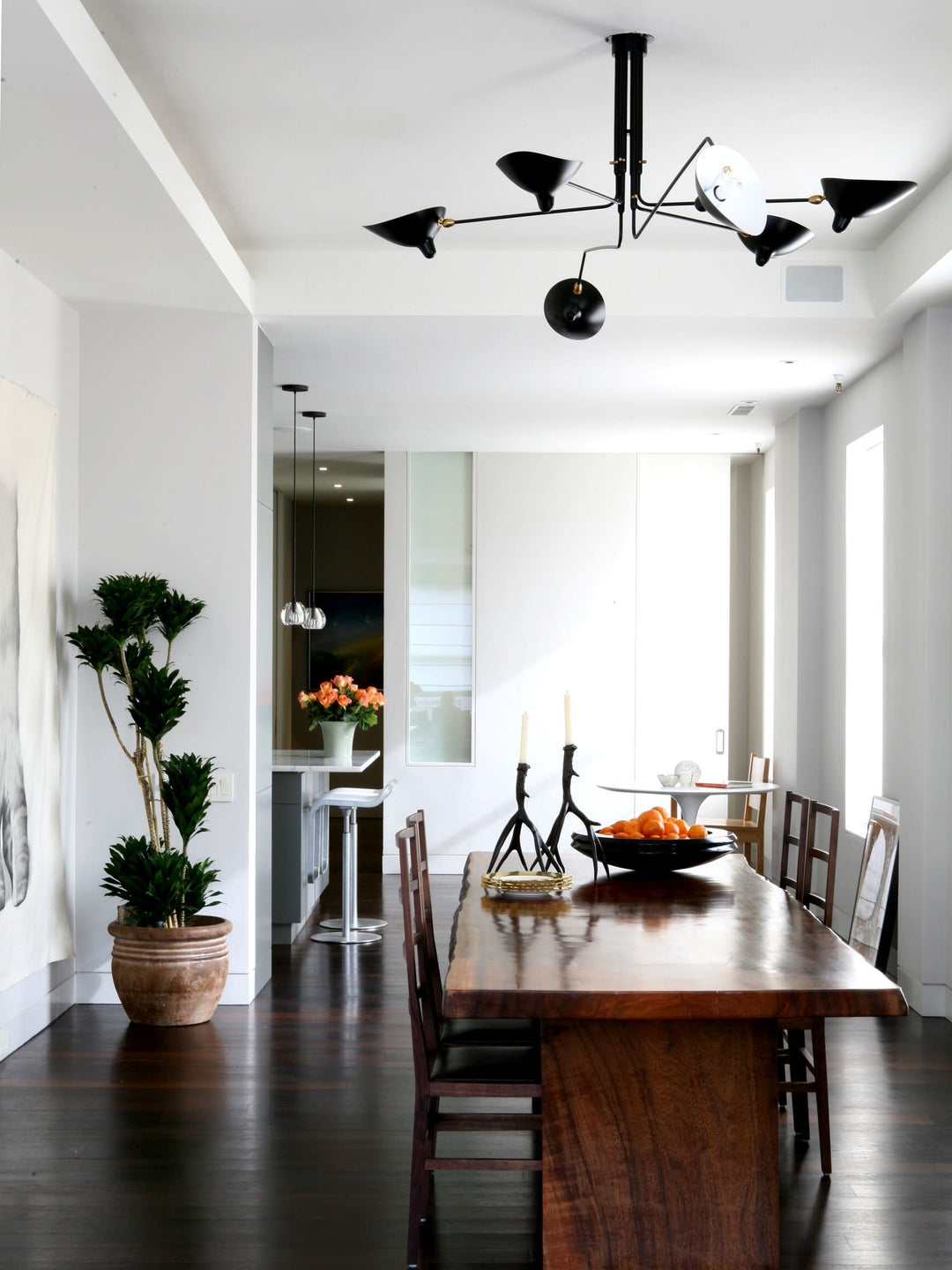 "Adjustable ceiling light with multiple arms, minimalist design, ideal for modern interiors, made of steel and aluminium."