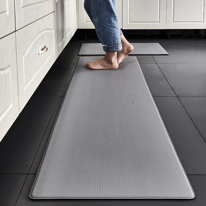 "Anti-slip waterproof kitchen rug with comfort cushioning, durable PVC, two-sided no-slip design, in grey rhombus pattern."