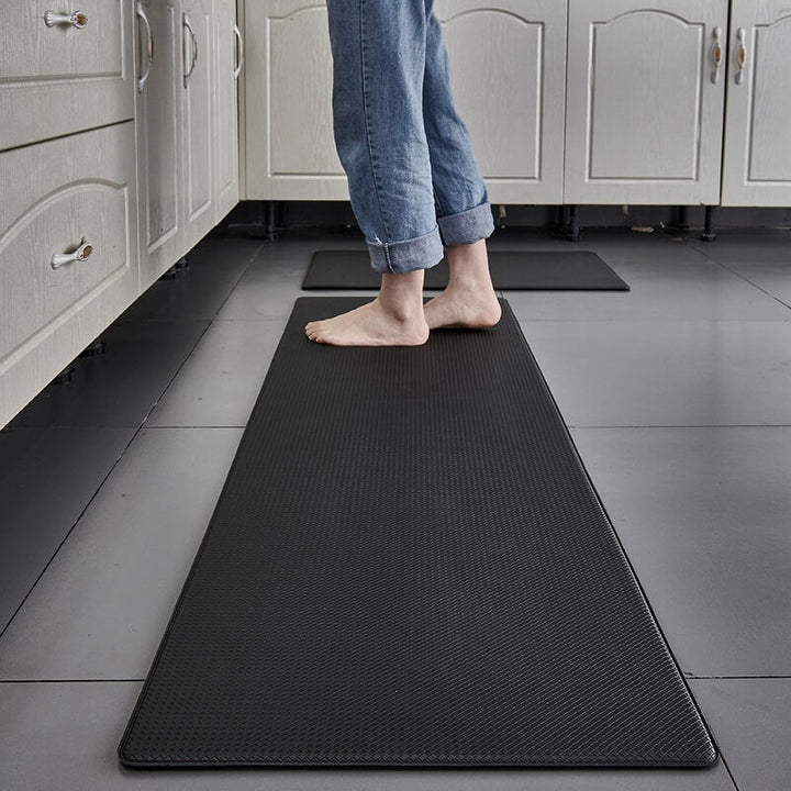 "Anti-slip waterproof kitchen rug with comfort cushioning, durable PVC, two-sided no-slip design, in grey rhombus pattern."