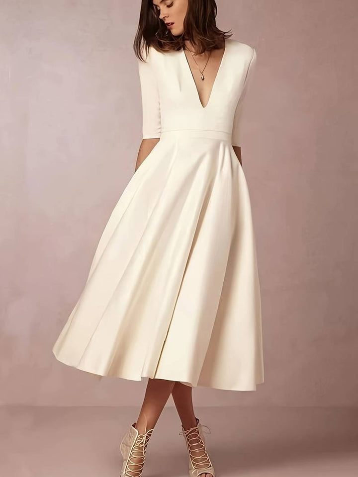 "Black A-Line V-Neck Short Sleeve Mini Dress for Spring/Summer, women's flattering silhouette, breezy and elegant style."