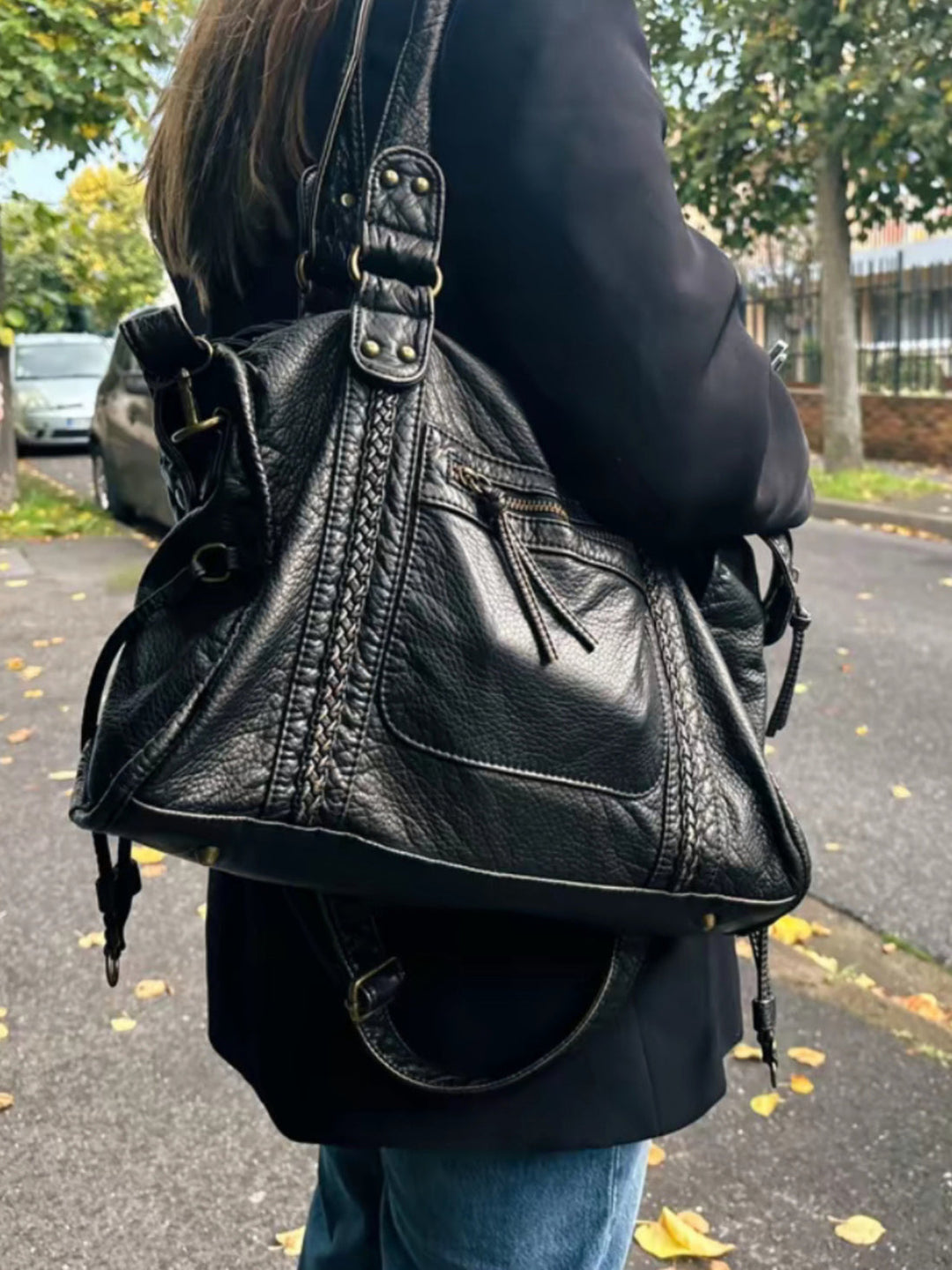 "Black vegan leather shoulder bag for women with elegant design, adjustable strap, and secure closures, perfect for daily use