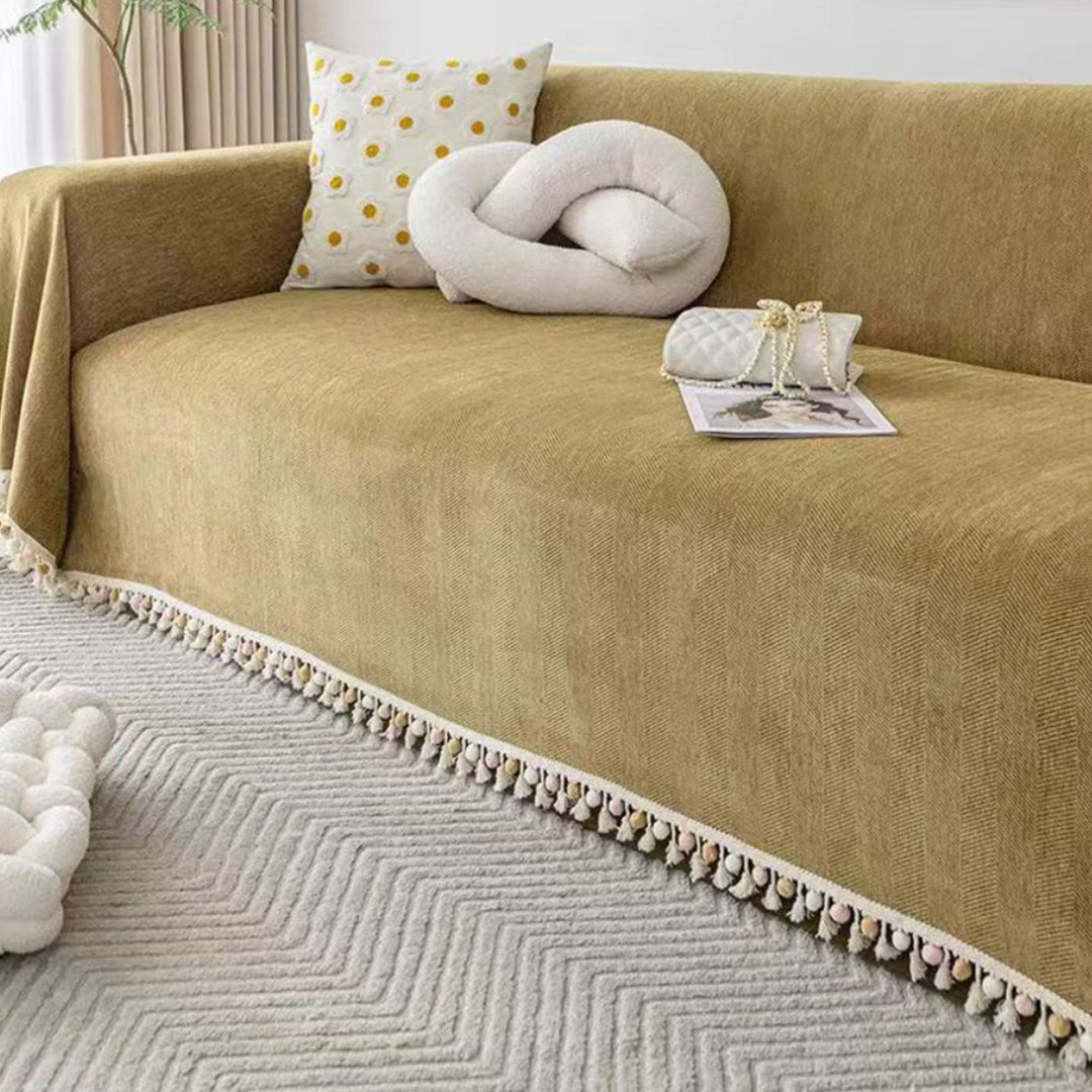 Boho style pet-friendly sofa cover with herringbone pattern and tassels, ideal for stylish protection in living rooms.
