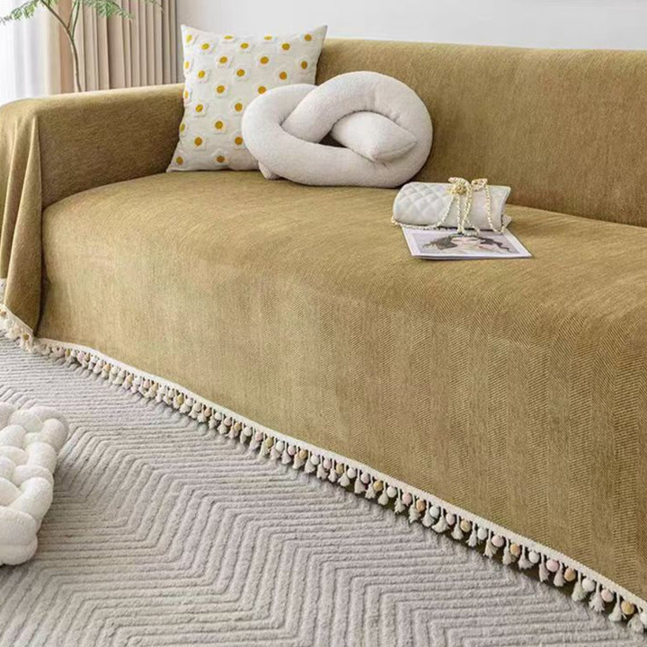 Boho style pet-friendly sofa cover with herringbone pattern and tassels, ideal for stylish protection in living rooms.