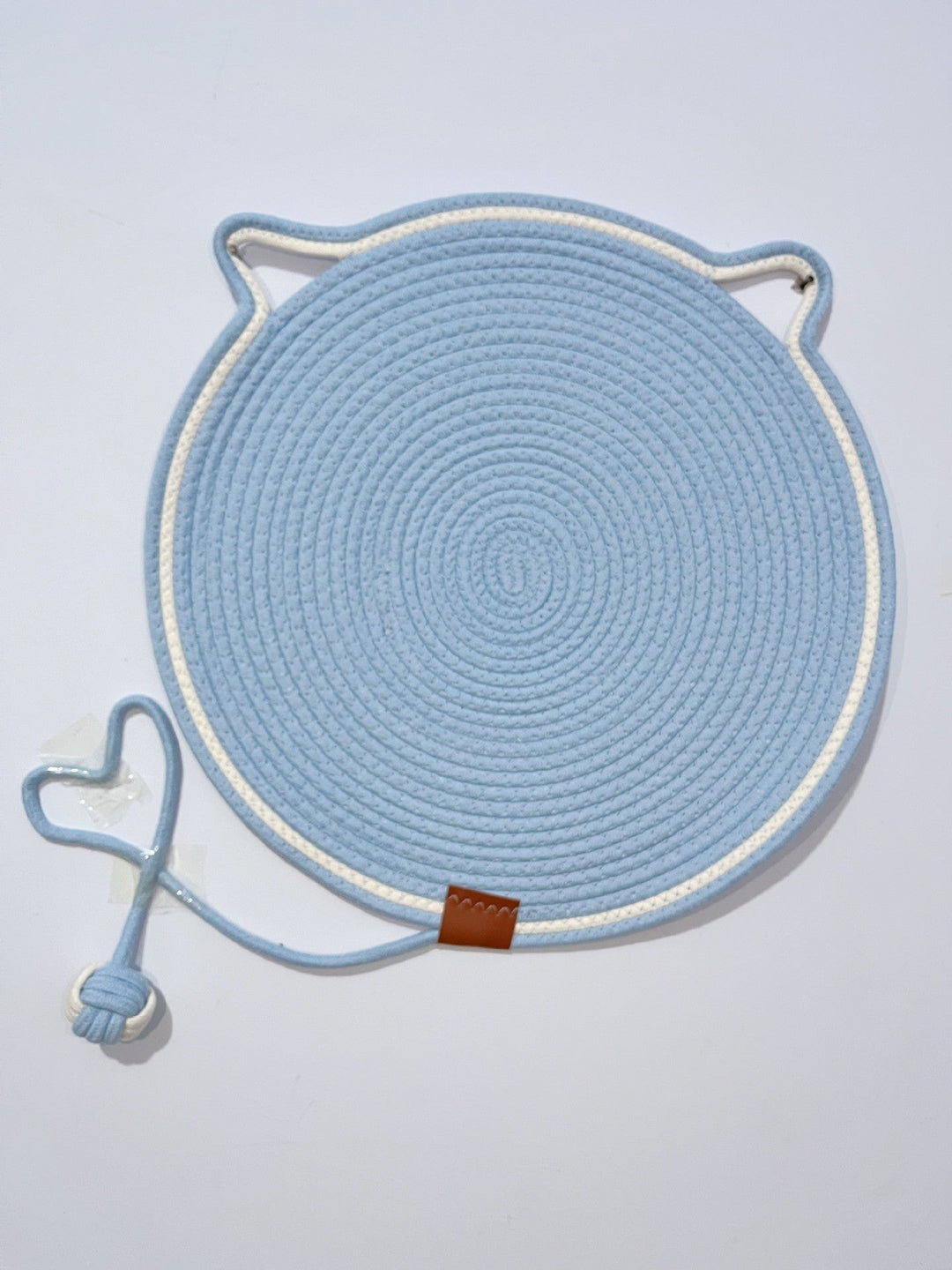 "Cat lounging on stylish, durable cat scratching rug; elegant, textured mat for optimal claw care and furniture protection."