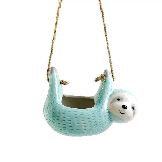 Ceramic sloth hanging flowerpot with hemp rope; whimsical design in blue, grey, or khaki, perfect for home decor.