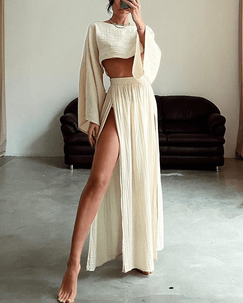 Women's elegant off-shoulder long-sleeve top & high-waist maxi skirt set. Fashionable two-piece outfit.