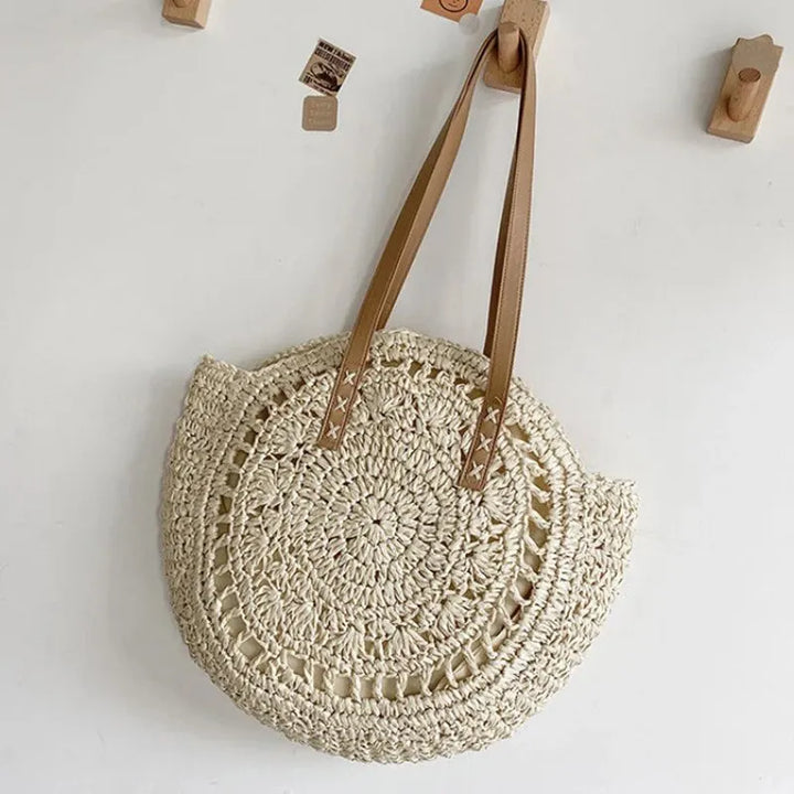 Chic & natural round woven beach tote bag. Women's summer shoulder bag, essential for stylish vacations.