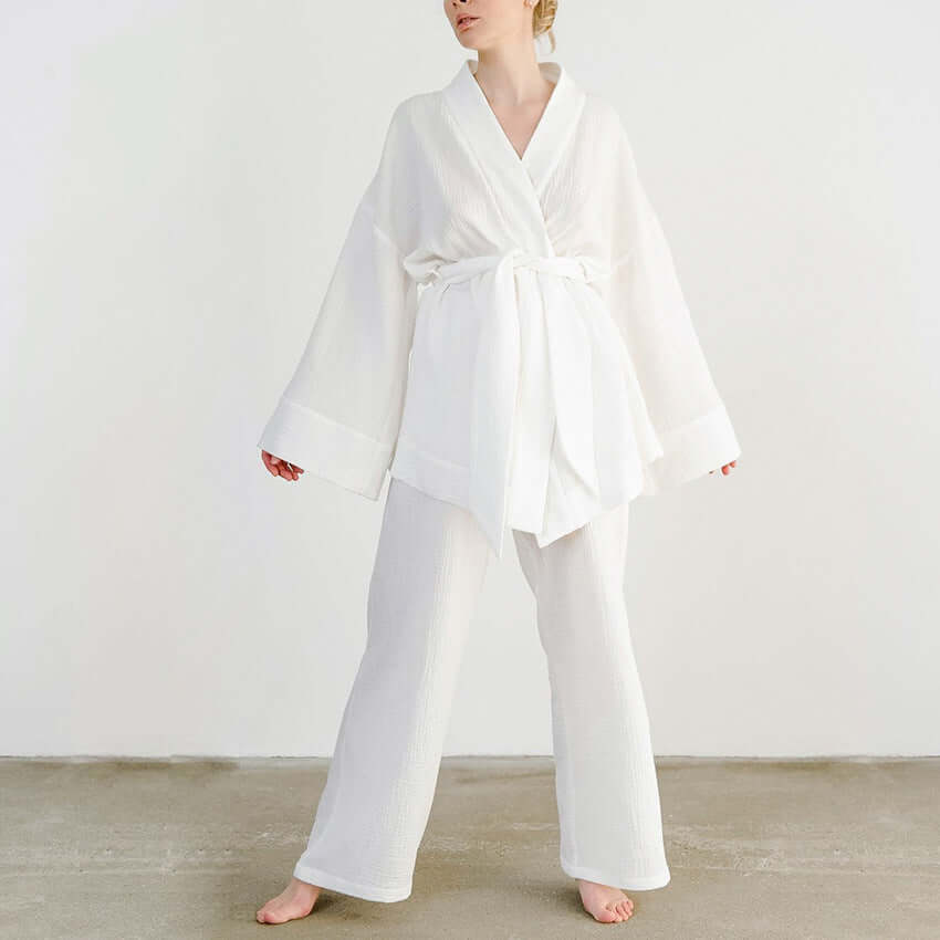 Women's versatile v-neck top & wide-leg trousers set with tie waist. Breathable style for elegant spring fashion.
