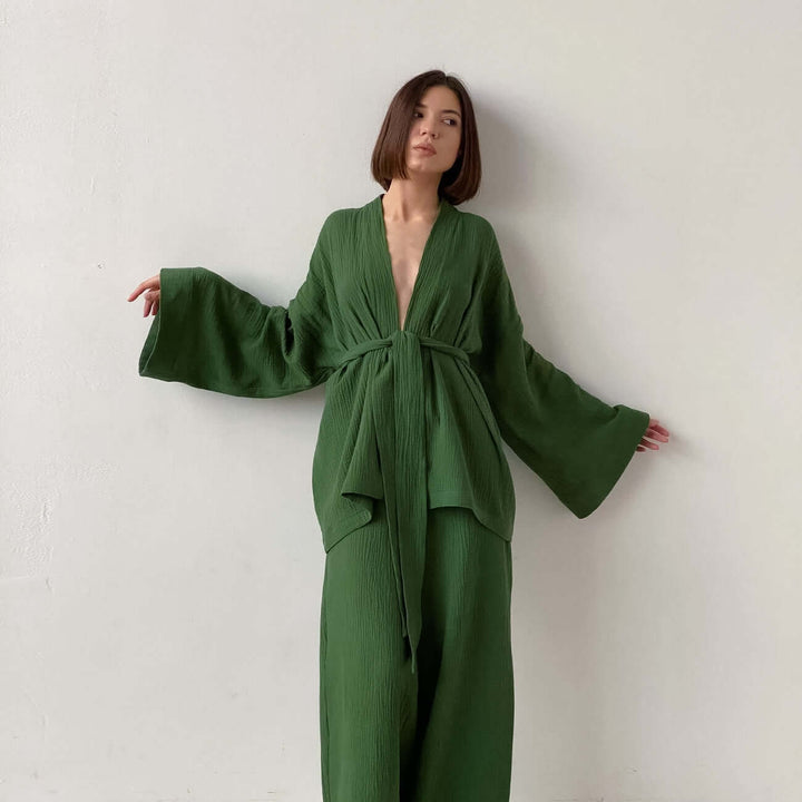 Women's chic two-piece V-neck top & wide-leg trousers set. Comfortable, elegant, and versatile for modern style.
