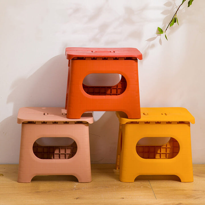 "Compact folding step stool with handle; durable plastic, various colors; perfect for kids and adults in any space."