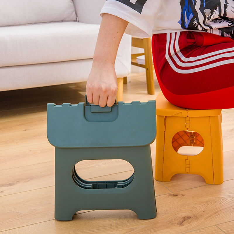 "Compact folding step stool with handle; durable plastic, various colors; perfect for kids and adults in any space."