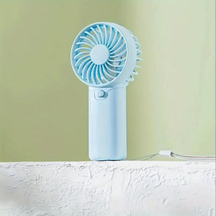"Compact portable mini fan, sleek design in white, pocket-sized cooler for travel or office, beauty wellbeing essential."
