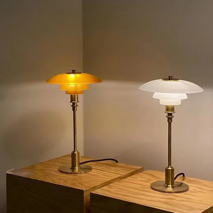 Contemporary Danish designer table lamp with warm LED light, sleek Scandinavian form, amber finish, and premium glass.