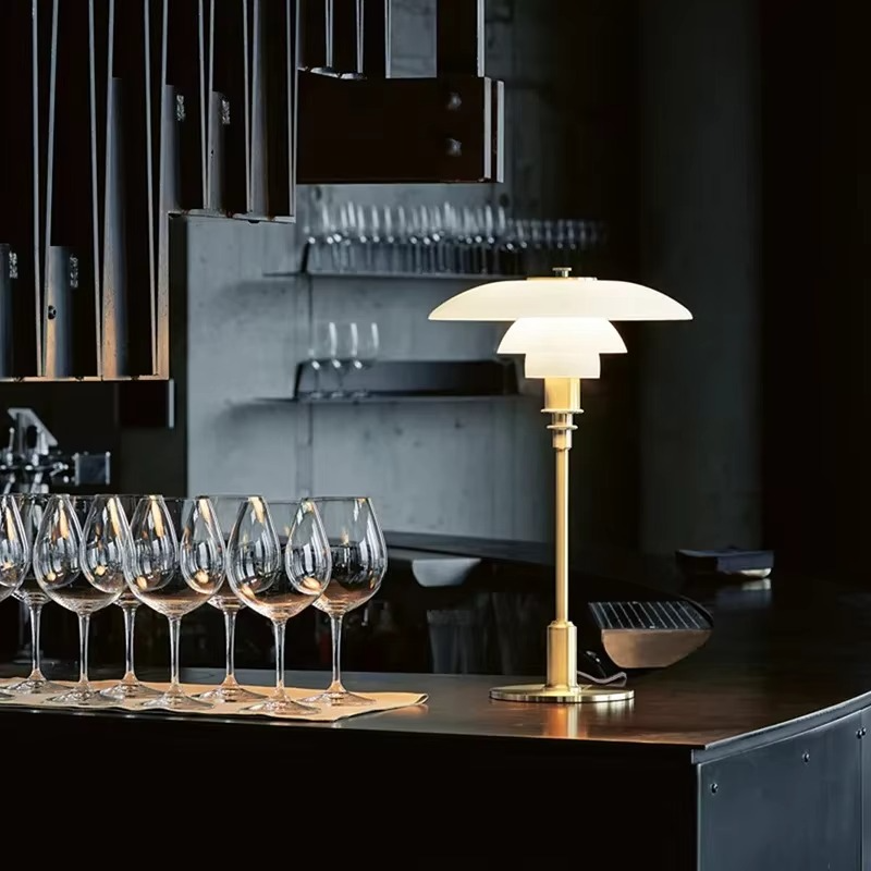 Contemporary Danish designer table lamp with warm LED light, sleek Scandinavian form, amber finish, and premium glass.