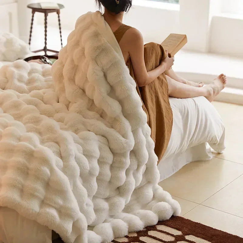 Cozy faux fur throw blanket, perfect for snuggling at home or during travel.