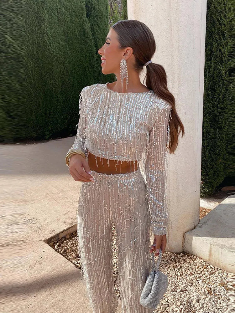 Women's dazzling sequin two-piece set: a chic crop top and high-waisted skirt. Ideal for glamorous party wear.