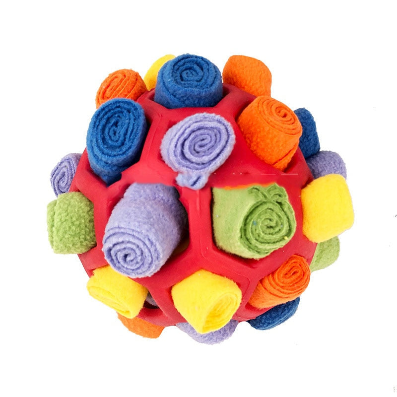 Dog's interactive snuffle treat ball in blue, green, and red, made of plush fleece and durable rubber for engaging playtime.