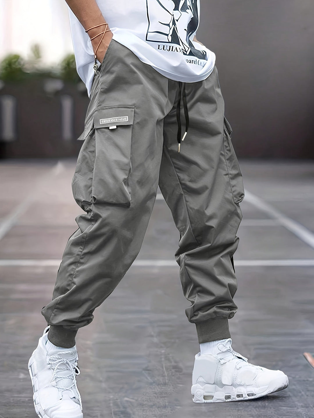 "Durable men's black cargo pants front view with multiple pockets, sleek modern fit, versatile style for urban adventures."