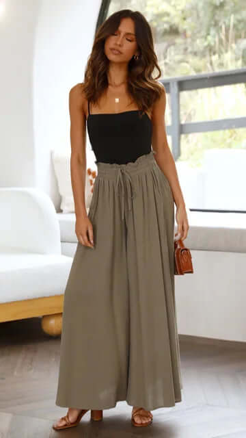 Woman lounging in comfortable women's loose fit drawstring trousers, perfect for relaxed weekends.
