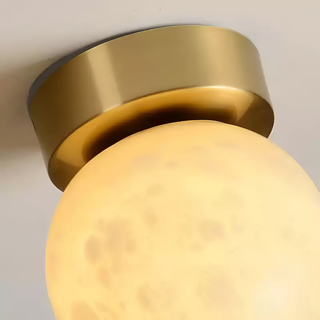 Elegant alabaster brass ceiling lamp, warm ambient light, celestial glow, sophisticated brass detailing, modern design.