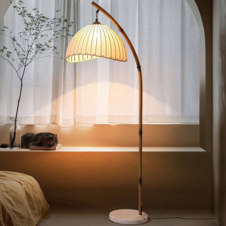Elegant bamboo floor lamp with fabric shade, offering ambient lighting for a relaxing ambiance in home decor settings.