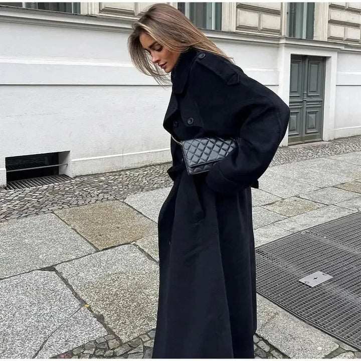 Sophisticated women's black double-breasted long coat, ideal transitional outerwear for elegant fashion.