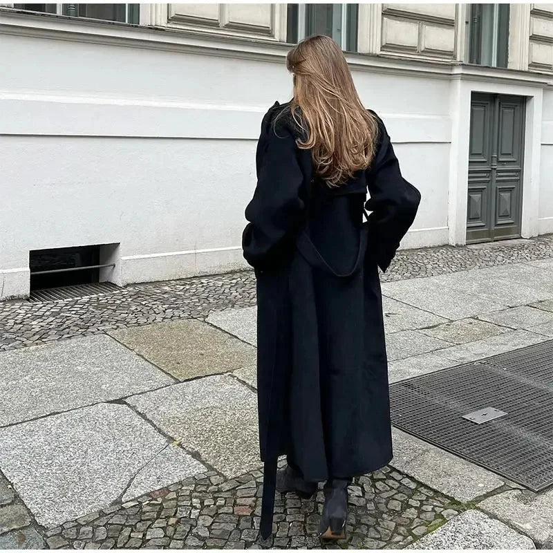 Classic black double-breasted long coat for women, offering an elegant & chic look for all occasions.