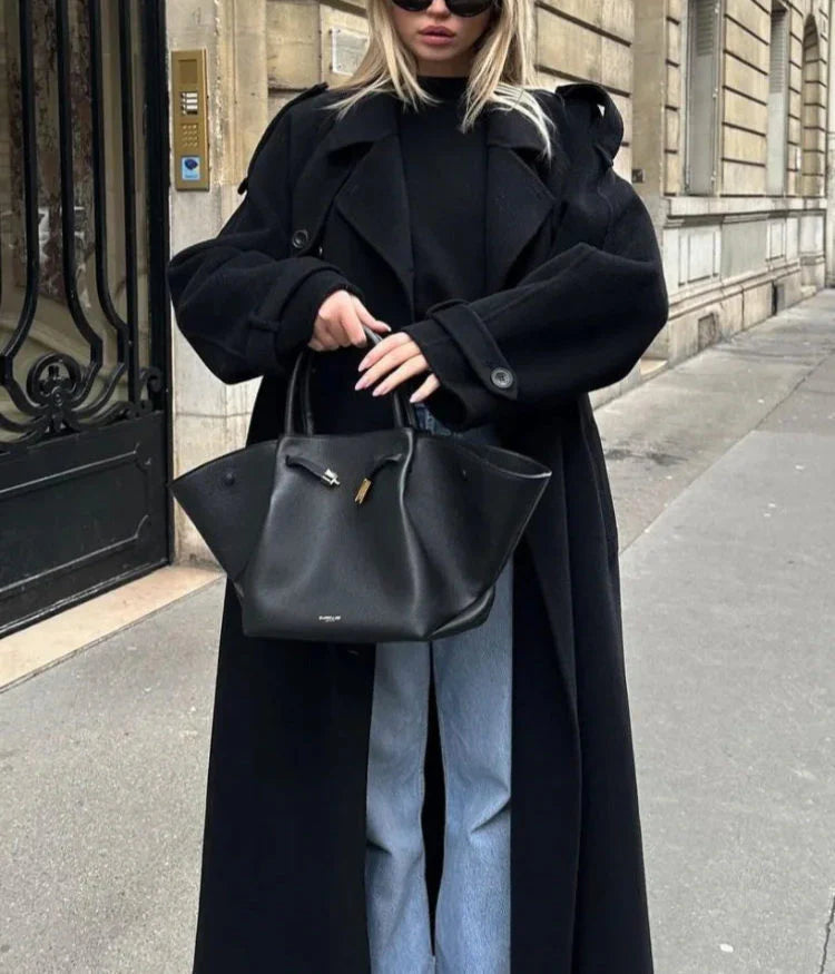 High-quality women's black double-breasted long coat, an elegant and sophisticated outerwear essential.