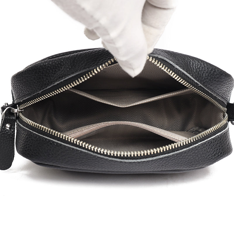 Sophisticated women's blue leather handbag, featuring an adjustable crossbody strap and elegant design.