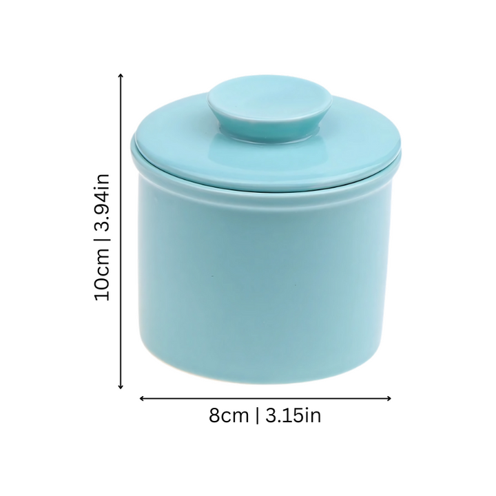 "Elegant ceramic butter keeper with water-sealed system in sleek black, light blue, and white, perfect for kitchen décor."