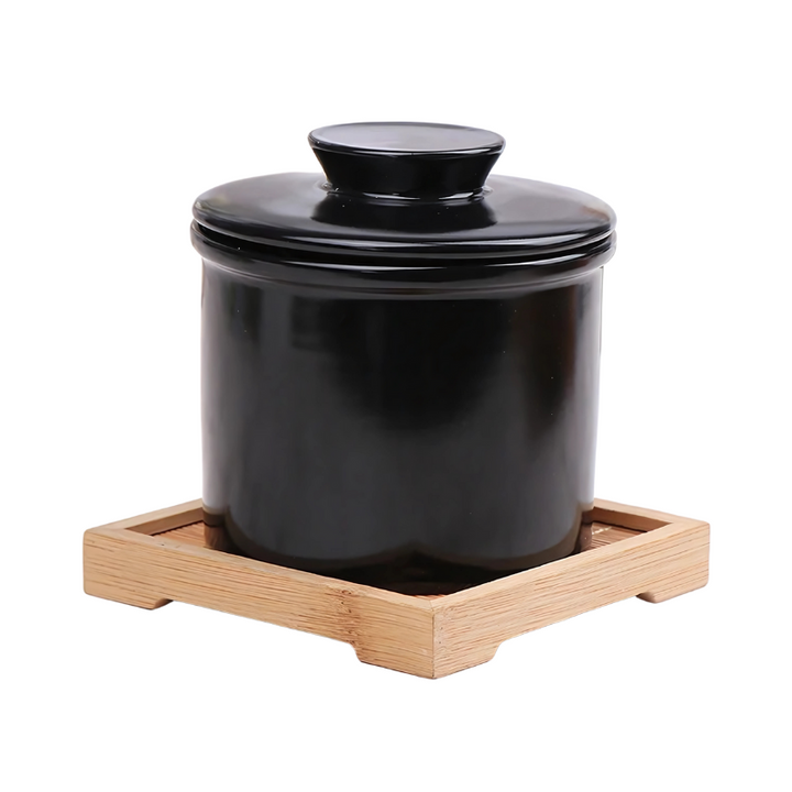 "Elegant ceramic butter keeper with water-sealed system in sleek black, light blue, and white, perfect for kitchen décor."