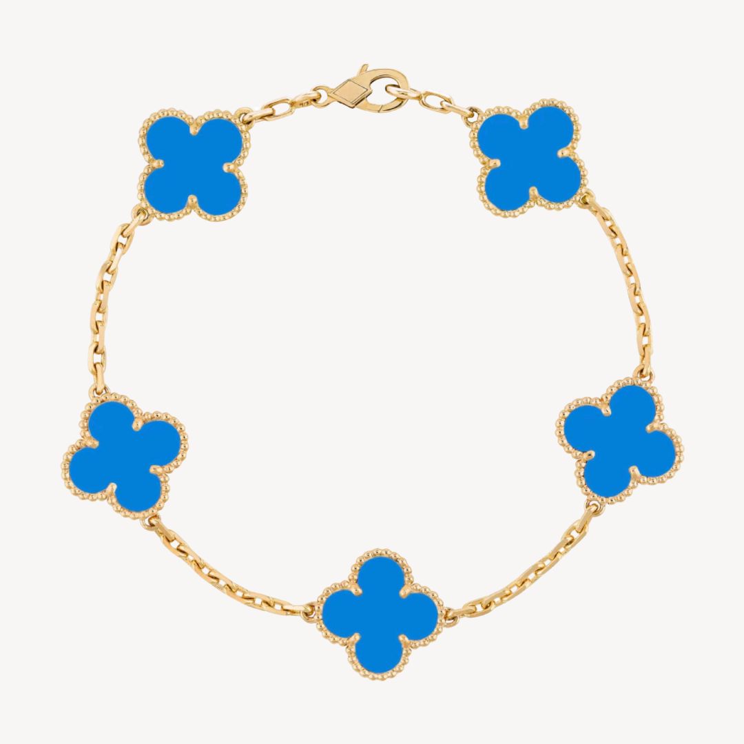 Elegant clover charm bracelet with polished black agate inlays and a gold and silver-tone chain for sophisticated style.