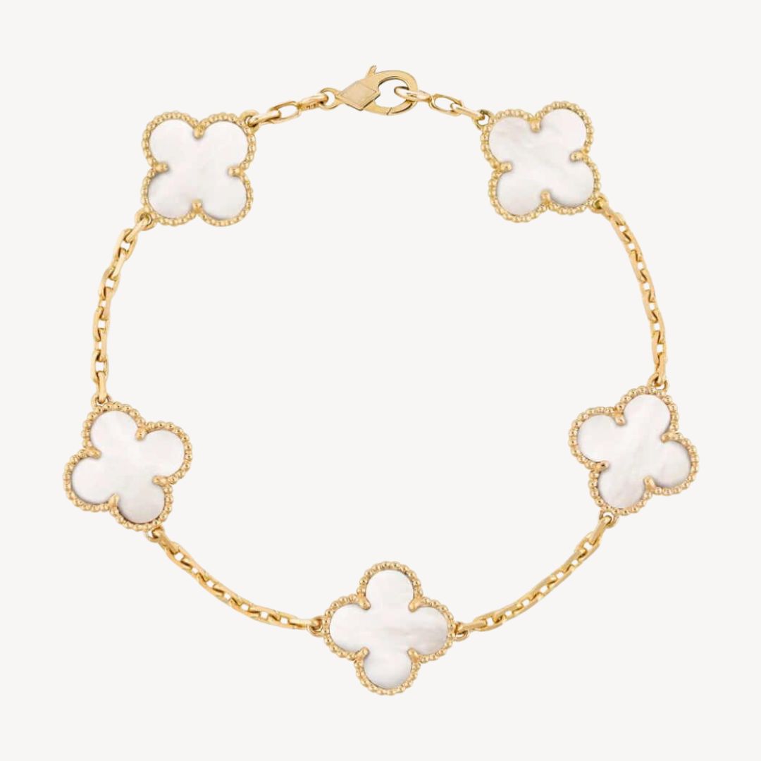Elegant clover charm bracelet with polished black agate inlays and a gold and silver-tone chain for sophisticated style.