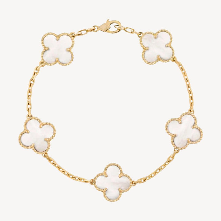 Elegant clover charm bracelet with polished black agate inlays and a gold and silver-tone chain for sophisticated style.