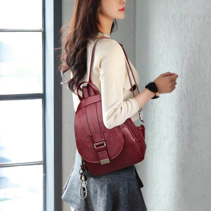 Front pocket detail on elegant water-resistant women's leather backpack.