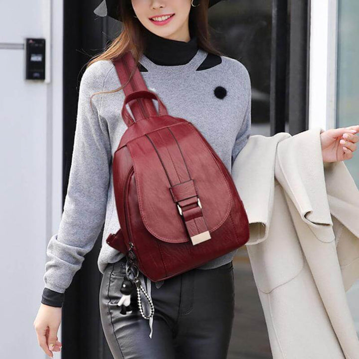 Elegant water-resistant sheepskin leather backpack for women, urban setting.