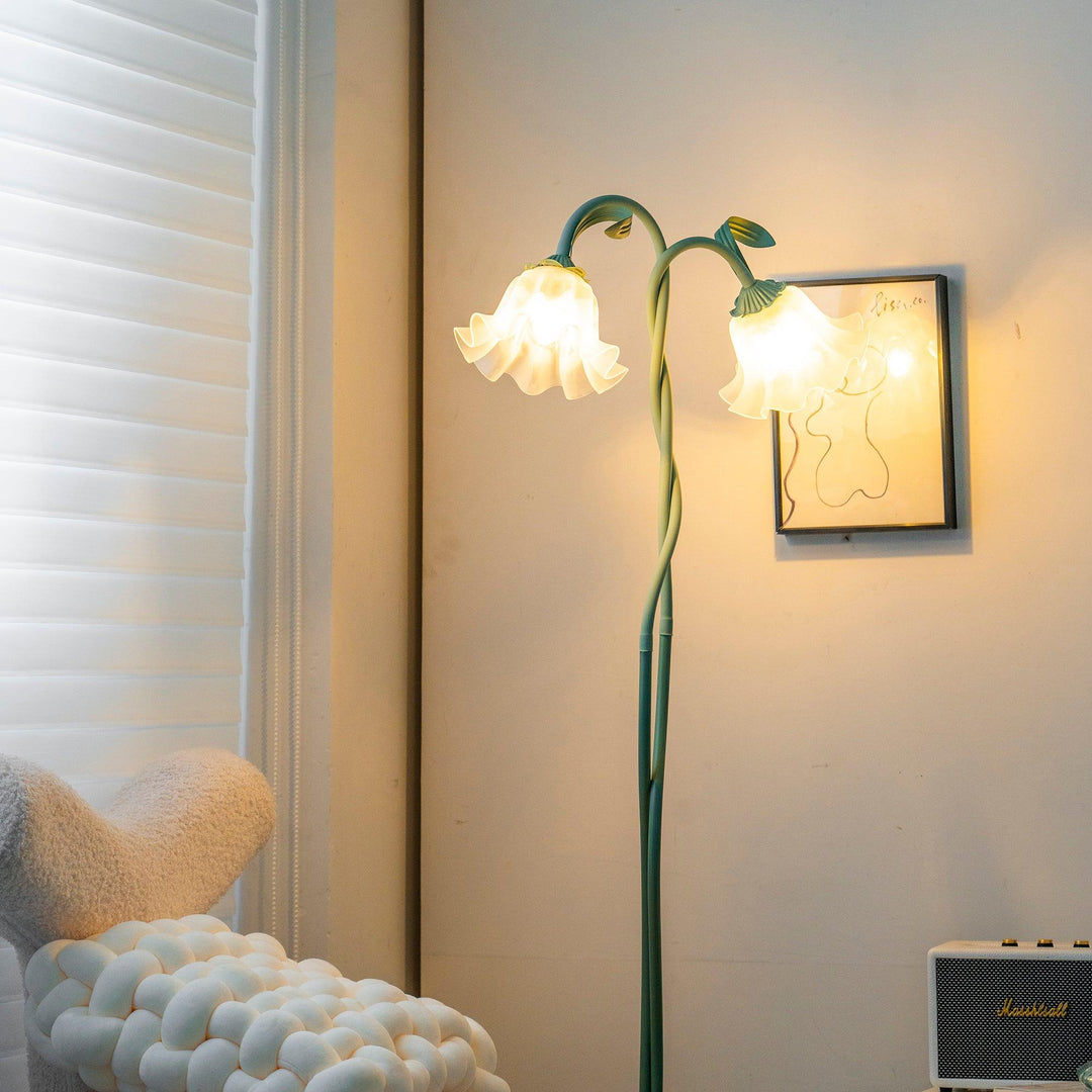 Elegant green floor lamp with white calla flower accents, matte finish, and metal construction, enhancing home decor.