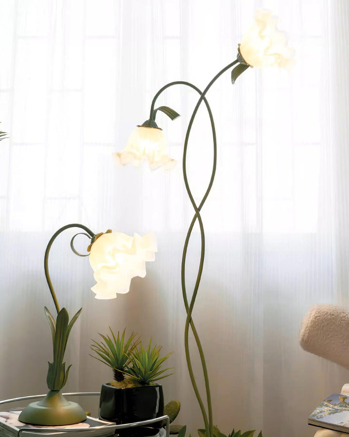 Elegant green floor lamp with white calla flower accents, matte finish, and metal construction, enhancing home decor.