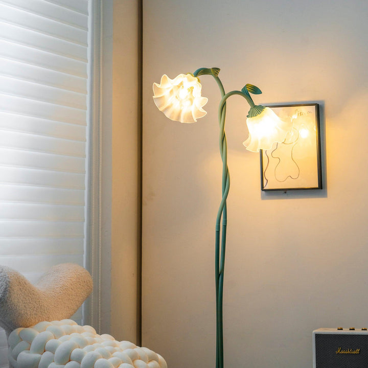 Elegant green floor lamp with white calla flower accents, matte finish, and metal construction, enhancing home decor.