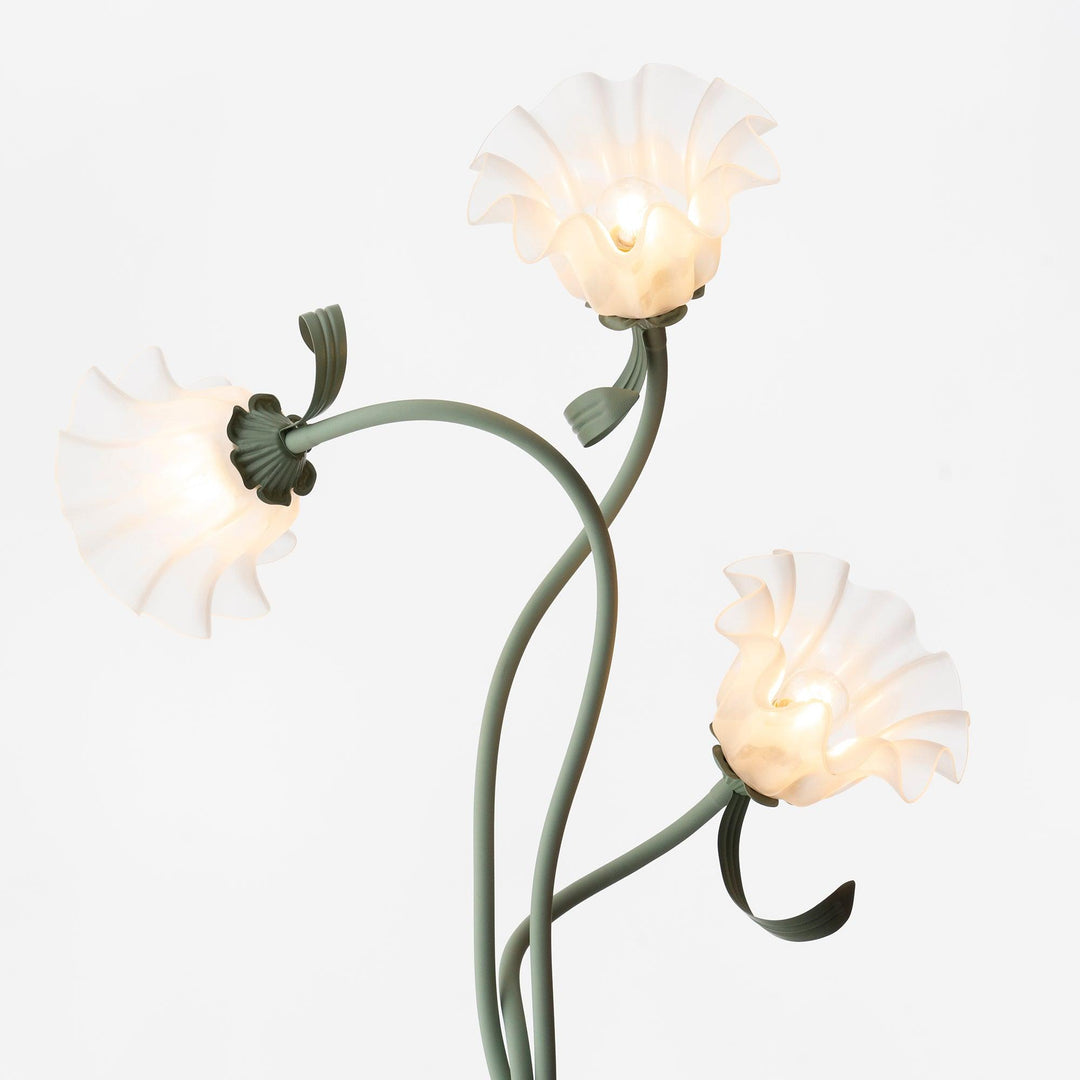 Elegant green floor lamp with white calla flower accents, matte finish, and metal construction, enhancing home decor.
