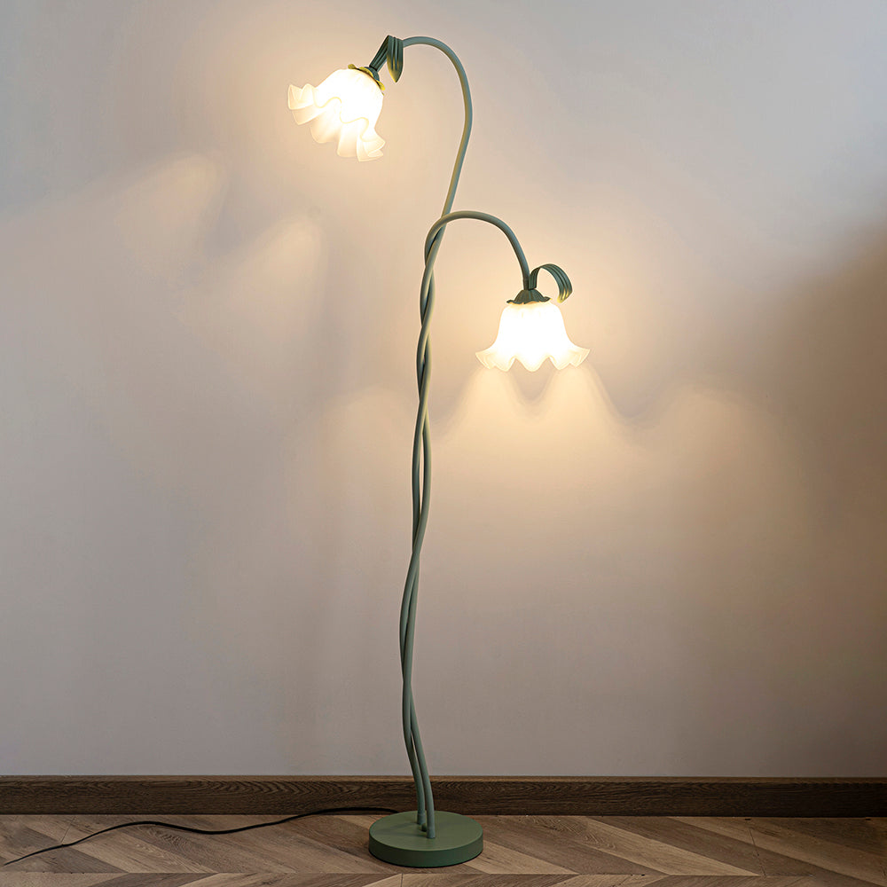 Elegant green floor lamp with white calla flower accents, matte finish, and metal construction, enhancing home decor.