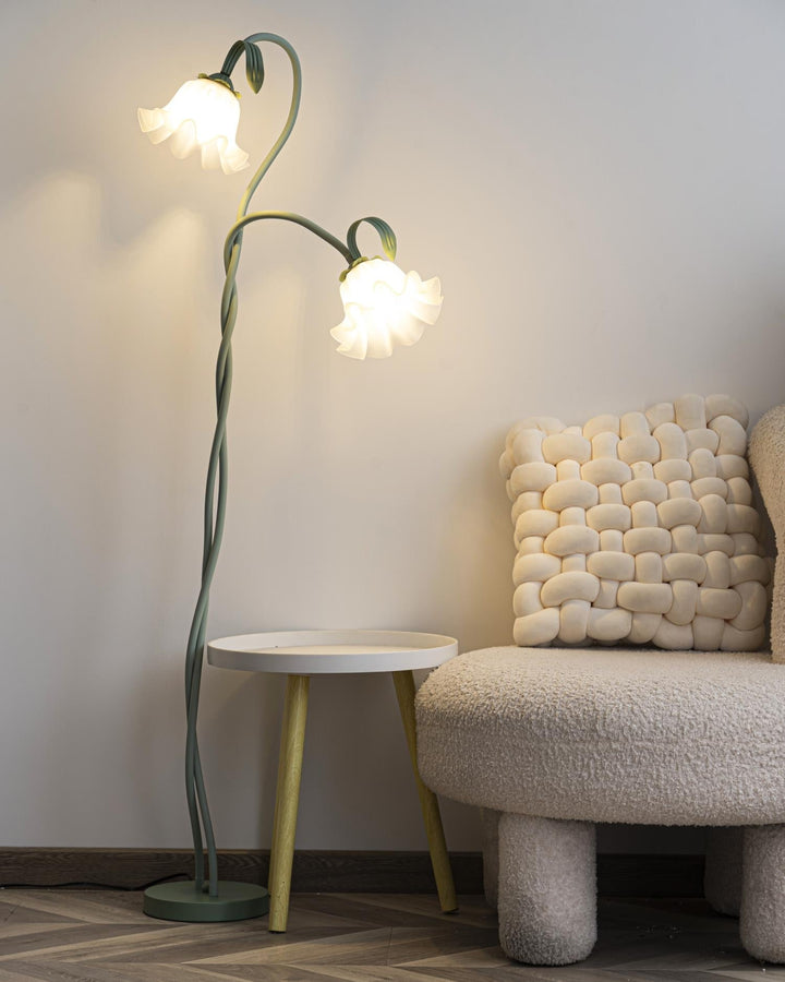 Elegant green floor lamp with white calla flower accents, matte finish, and metal construction, enhancing home decor.