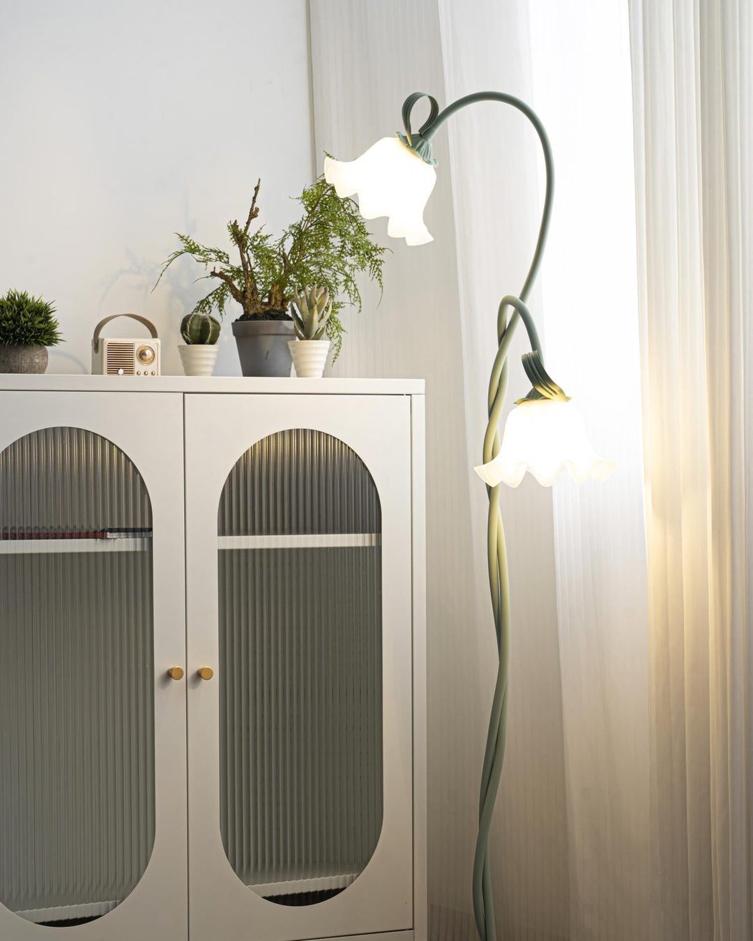Elegant green floor lamp with white calla flower accents, matte finish, and metal construction, enhancing home decor.