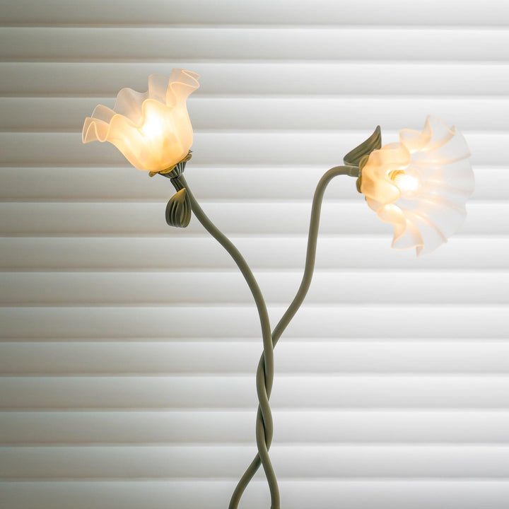 Elegant green floor lamp with white calla flower accents, matte finish, and metal construction, enhancing home decor.
