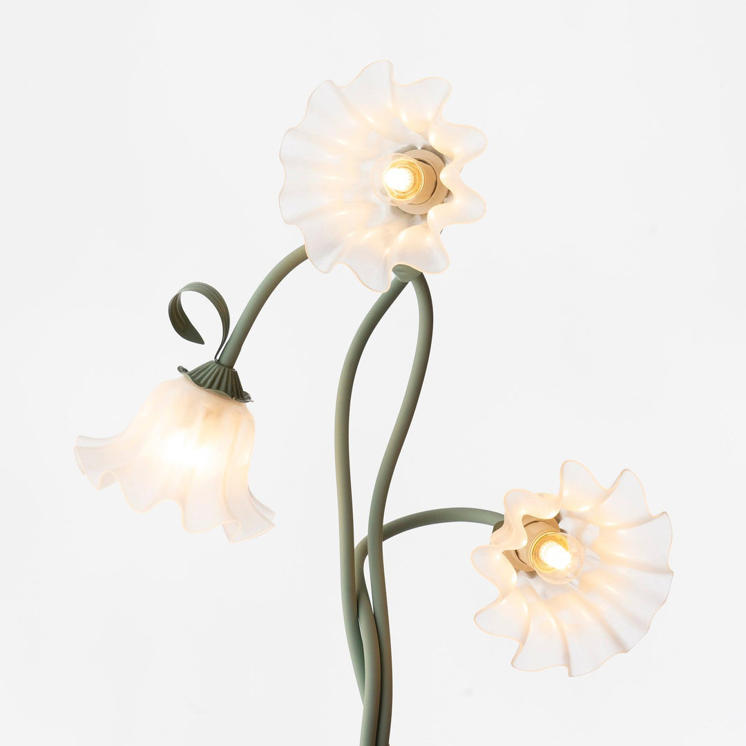 Elegant green floor lamp with white calla flower accents, matte finish, and metal construction, enhancing home decor.