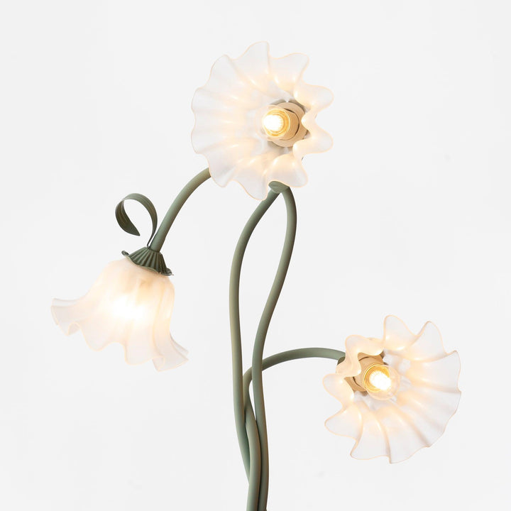 Elegant green floor lamp with white calla flower accents, matte finish, and metal construction, enhancing home decor.