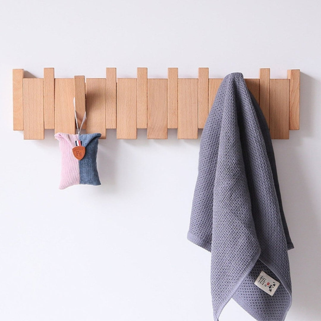 "Elegant handmade wooden piano coatrack front view, showcasing unique piano key design and quality craftsmanship in home deco