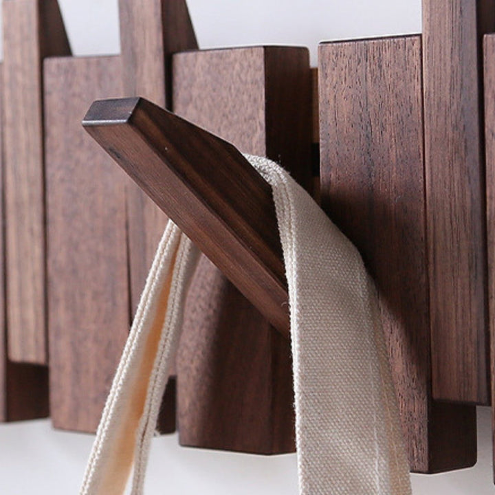 "Elegant handmade wooden piano coatrack front view, showcasing unique piano key design and quality craftsmanship in home deco