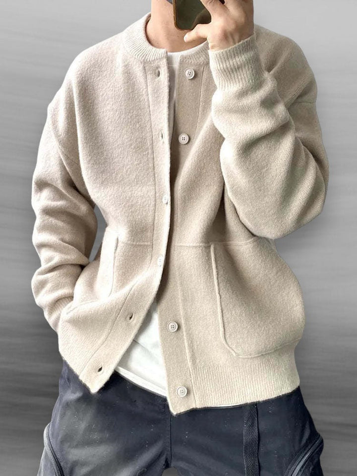 Elegant men's knitted cardigan in beige, showcasing ribbed cuffs and hem, perfect for casual or semi-formal wear.