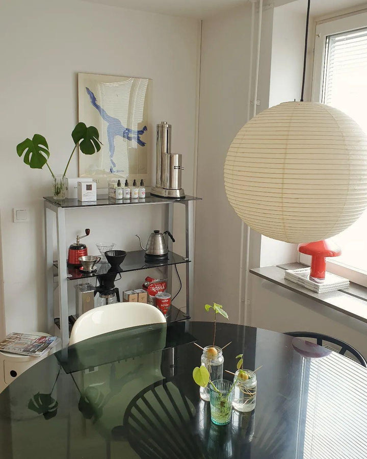 "Elegant modern Japanese paper lantern pendant light with a warm glow, blending contemporary and mid-century design."